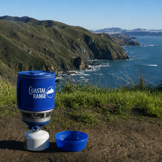 The Backpacker ultralight integrated camping stove with 1.2 L pot on a coastal overlook